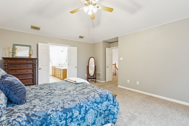 bedroom featuring light colored carpet, baseboards, a ceiling fan, and ensuite bathroom