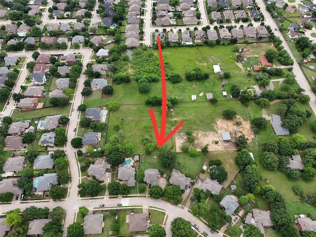 aerial view of property and surrounding area featuring nearby suburban area