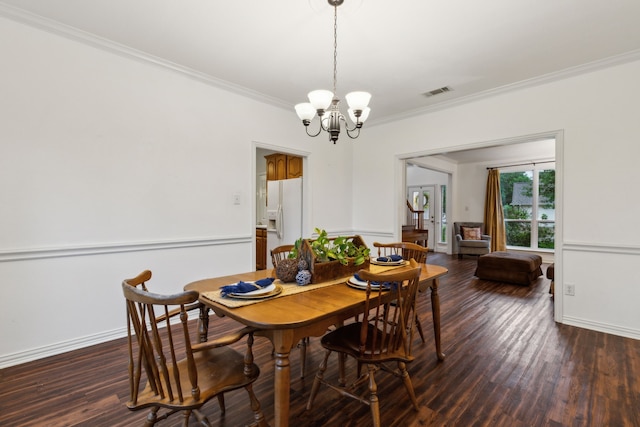 dining room with crown molding, a chandelier, dark wood finished floors, and baseboards