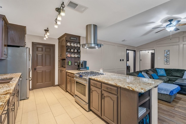 kitchen featuring appliances with stainless steel finishes, ventilation hood, open shelves, open floor plan, and a peninsula
