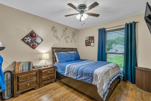 bedroom with wood finished floors and ceiling fan