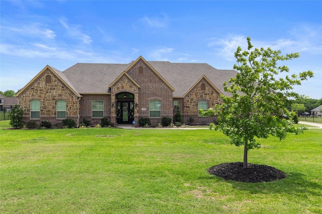 2416 Sweeping Meadows Ln, Cedar Hill, TX 75104 - french country home featuring stone siding, a front lawn, and brick siding
