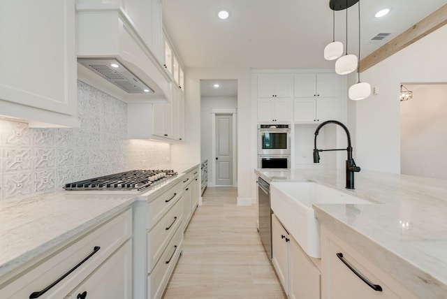 kitchen featuring a sink, appliances with stainless steel finishes, recessed lighting, decorative backsplash, and white cabinets