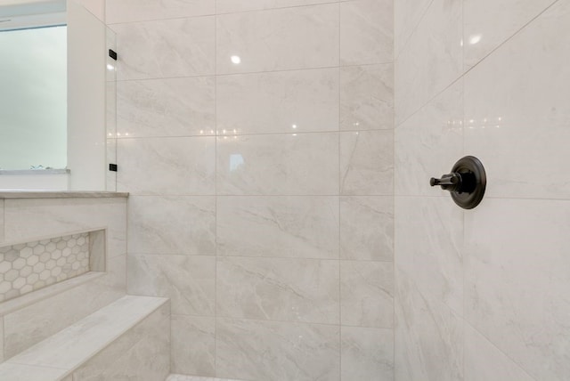 bathroom with tiled shower
