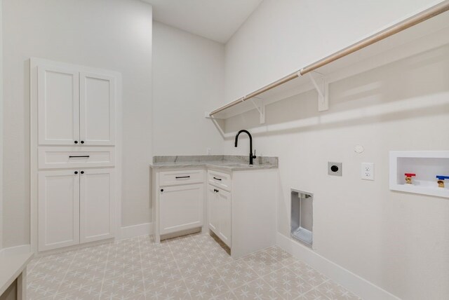 laundry room with electric dryer hookup, baseboards, hookup for a washing machine, hookup for a gas dryer, and light floors