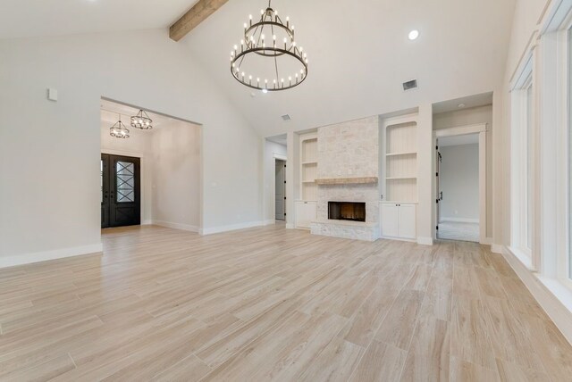 unfurnished living room with a chandelier, beamed ceiling, high vaulted ceiling, built in features, and light wood finished floors