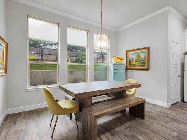 2209 Trace Ridge Dr, Weatherford, TX 76087 - dining room featuring baseboards, wood finished floors, and crown molding