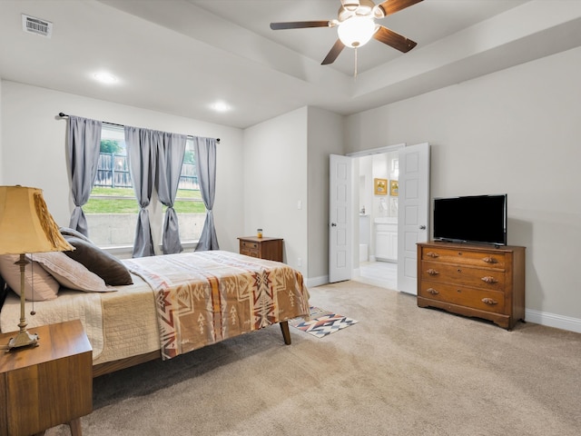 2209 Trace Ridge Dr, Weatherford, TX 76087 - bedroom with carpet, baseboards, ensuite bath, a tray ceiling, and a ceiling fan