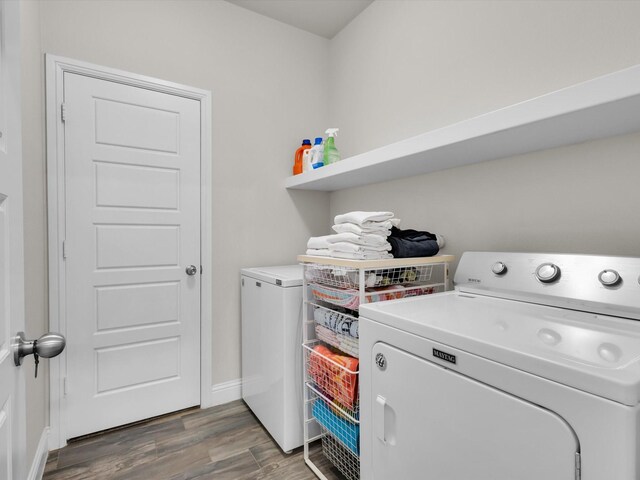 2209 Trace Ridge Dr, Weatherford, TX 76087 - laundry area with washer and dryer, wood finished floors, and baseboards