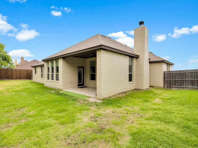 2209 Trace Ridge Dr, Weatherford, TX 76087 - rear view of house featuring a chimney, a patio, a shingled roof, and brick siding