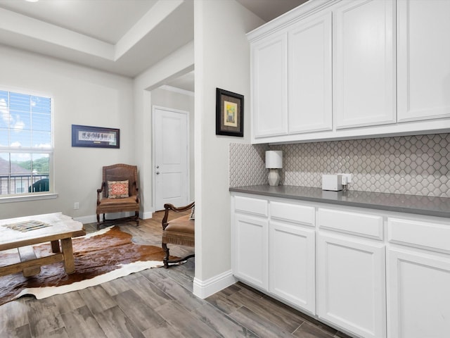 2209 Trace Ridge Dr, Weatherford, TX 76087 - kitchen featuring backsplash, white cabinetry, dark wood-style flooring, and baseboards