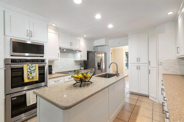 kitchen featuring stainless steel appliances, a sink, under cabinet range hood, white cabinetry, and recessed lighting