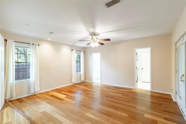 empty room featuring light wood-style flooring, a ceiling fan, baseboards, and recessed lighting
