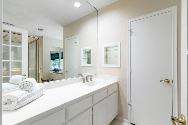 full bathroom featuring a stall shower and vanity