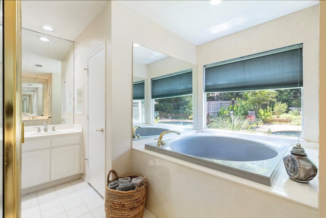 full bathroom featuring vanity, a bath, tile patterned flooring, and recessed lighting
