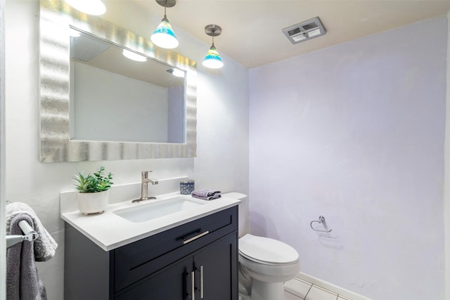 bathroom with tile patterned flooring, vanity, and toilet
