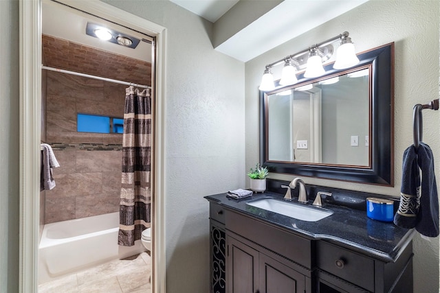full bathroom with a textured wall, toilet, vanity, shower / bath combo, and tile patterned flooring