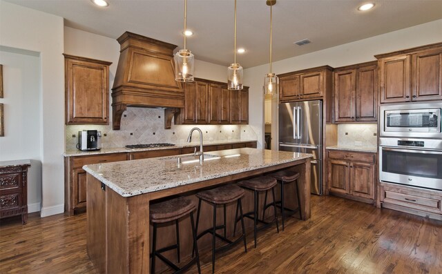 4625 Man O War Rd, Carrollton, TX 75010 - kitchen featuring stainless steel appliances, a sink, premium range hood, dark wood-style flooring, and backsplash