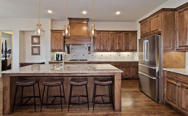 4625 Man O War Rd, Carrollton, TX 75010 - kitchen with appliances with stainless steel finishes, custom range hood, a kitchen island with sink, dark wood-type flooring, and a kitchen bar