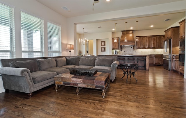 4625 Man O War Rd, Carrollton, TX 75010 - living area featuring dark wood-style floors, a chandelier, and recessed lighting