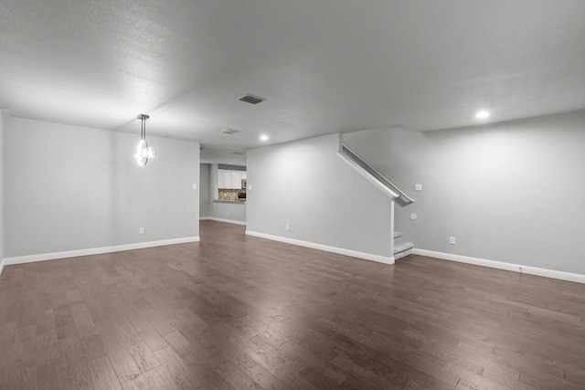 2720 Ocaso Dr, Little Elm, TX 75068 - below grade area with stairs, dark wood-style floors, baseboards, and recessed lighting