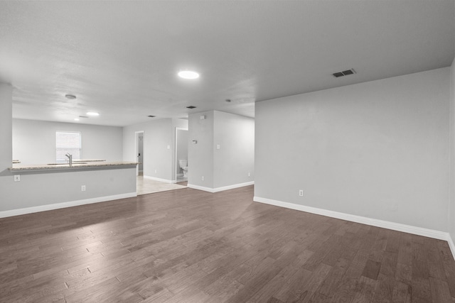 2720 Ocaso Dr, Little Elm, TX 75068 - unfurnished room featuring dark wood finished floors, baseboards, and a sink