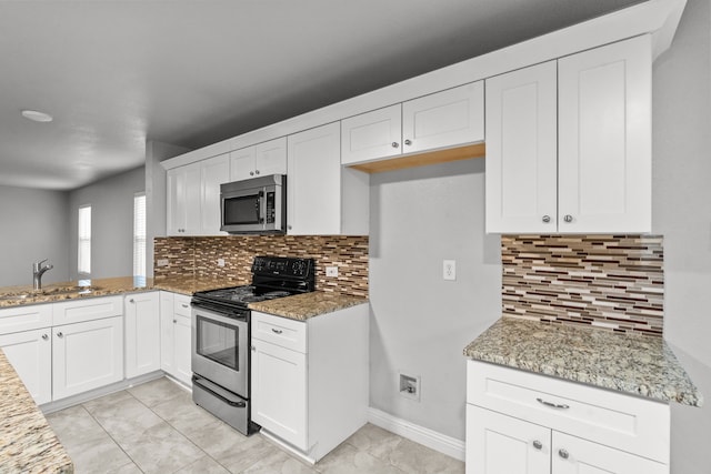 2720 Ocaso Dr, Little Elm, TX 75068 - kitchen featuring stainless steel appliances, a sink, and light stone counters