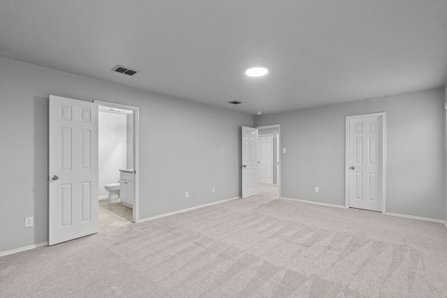 2720 Ocaso Dr, Little Elm, TX 75068 - unfurnished bedroom with light carpet, baseboards, and ensuite bathroom