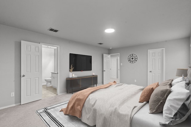 2720 Ocaso Dr, Little Elm, TX 75068 - bedroom with light colored carpet, baseboards, and ensuite bath