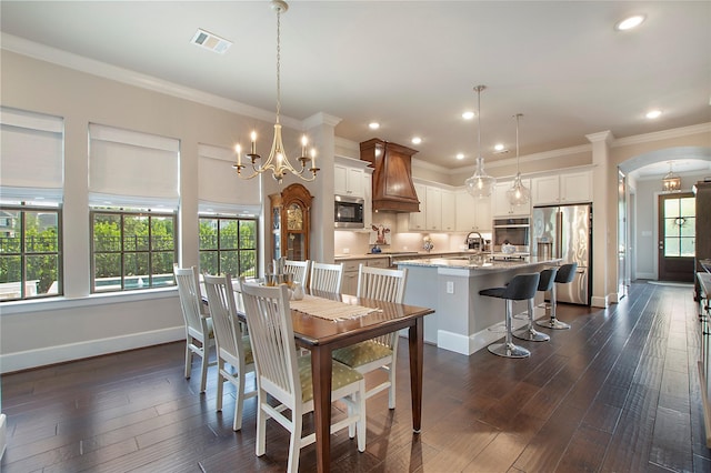 2700 Tremont Blvd, Mckinney, TX 75071 - dining room with baseboards, arched walkways, dark wood-type flooring, healthy amount of natural light, and recessed lighting