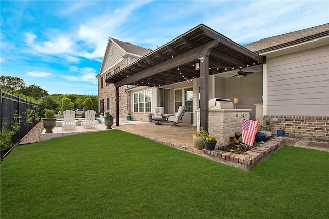2700 Tremont Blvd, Mckinney, TX 75071 - back of property with brick siding, a patio area, exterior kitchen, and ceiling fan