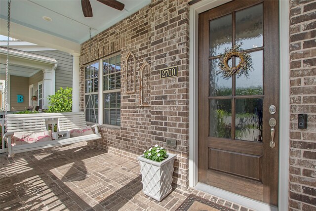2700 Tremont Blvd, Mckinney, TX 75071 - view of exterior entry with covered porch, brick siding, and ceiling fan