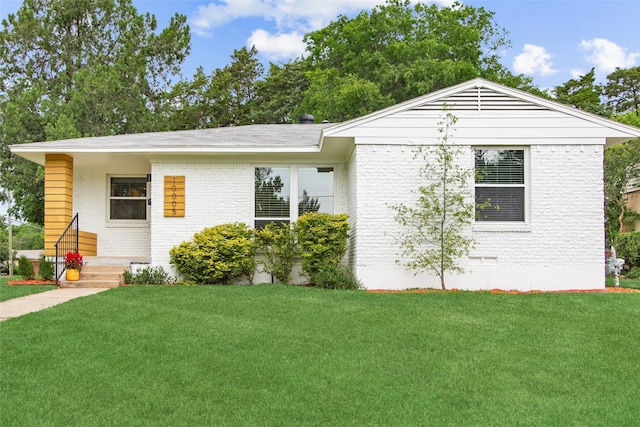 ranch-style home featuring brick siding, a front lawn, and crawl space