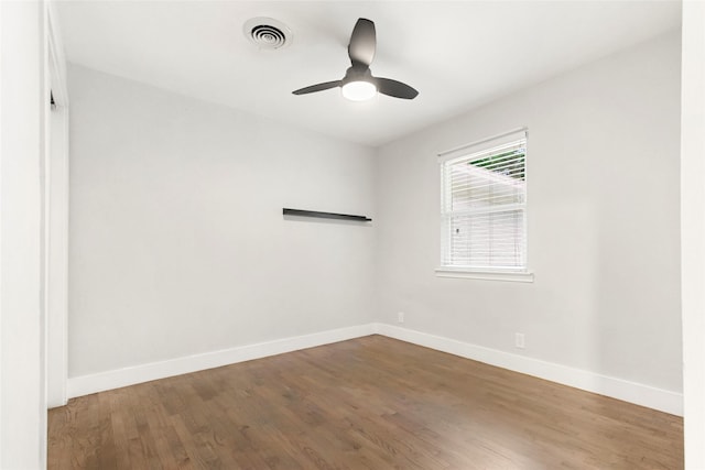 unfurnished room featuring baseboards, wood finished floors, and ceiling fan