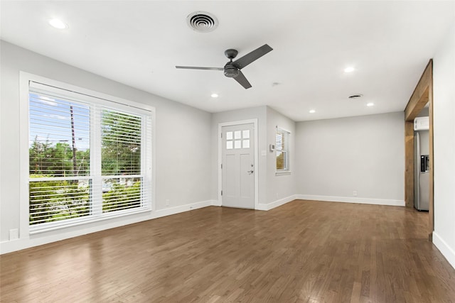 entryway with healthy amount of natural light, wood finished floors, ceiling fan, baseboards, and recessed lighting