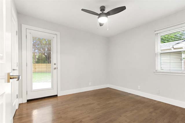 spare room featuring wood finished floors, baseboards, and a ceiling fan