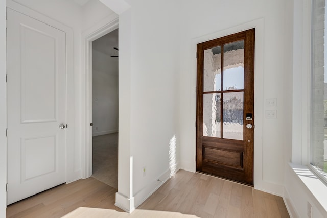 entryway with wood finished floors and baseboards