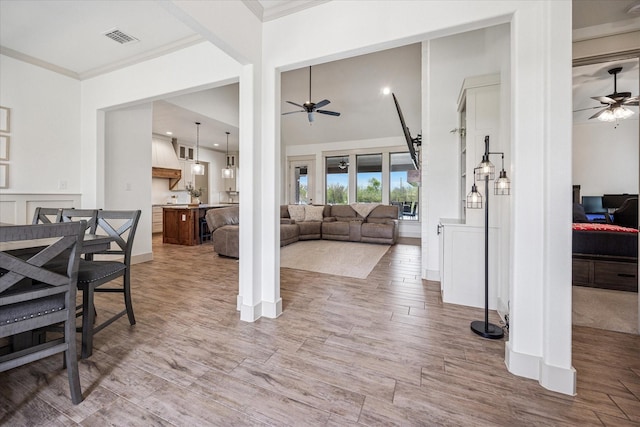 2028 Carrie Ct, Weatherford, TX 76088 - living room featuring a ceiling fan, crown molding, wood finished floors, and a high ceiling