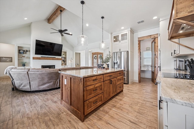 2028 Carrie Ct, Weatherford, TX 76088 - kitchen with stainless steel fridge with ice dispenser, black electric cooktop, ceiling fan, white cabinetry, and light wood-style floors