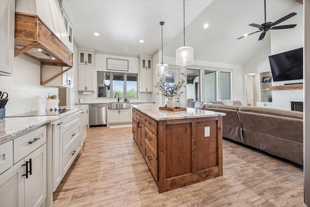 2028 Carrie Ct, Weatherford, TX 76088 - kitchen featuring a sink, black electric cooktop, white cabinetry, tasteful backsplash, and open floor plan