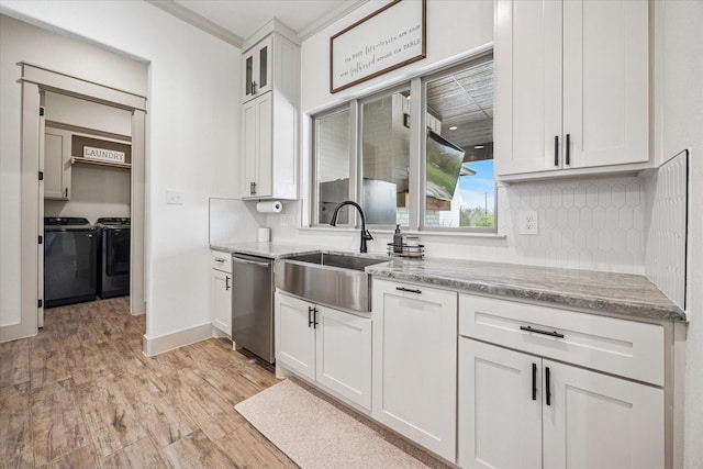2028 Carrie Ct, Weatherford, TX 76088 - kitchen featuring dishwasher, washing machine and clothes dryer, a sink, backsplash, and white cabinets