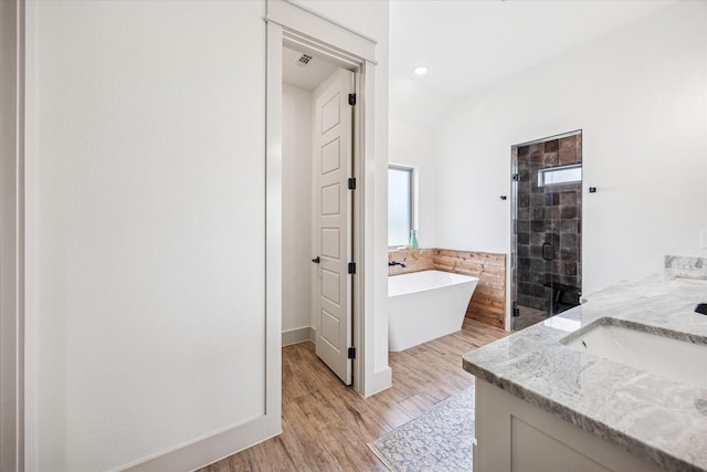 2028 Carrie Ct, Weatherford, TX 76088 - full bath with a shower stall, a freestanding tub, wood finished floors, and double vanity