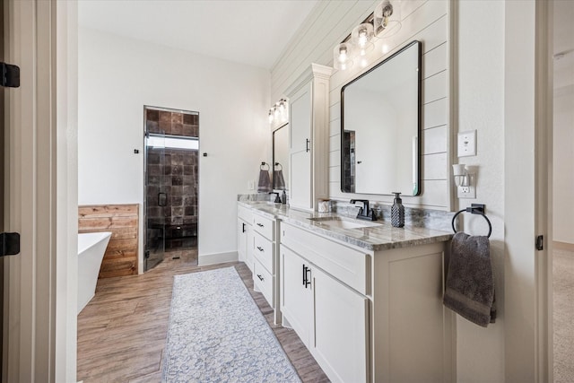 2028 Carrie Ct, Weatherford, TX 76088 - full bathroom featuring a shower stall, vanity, wood finished floors, and a freestanding bath