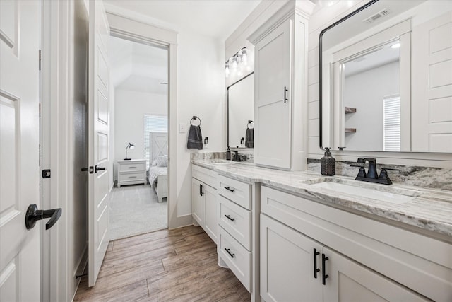 2028 Carrie Ct, Weatherford, TX 76088 - bathroom with wood finished floors, double vanity, and ensuite bathroom