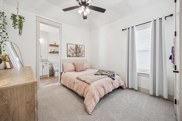 2028 Carrie Ct, Weatherford, TX 76088 - bedroom featuring light carpet, ensuite bath, and a ceiling fan