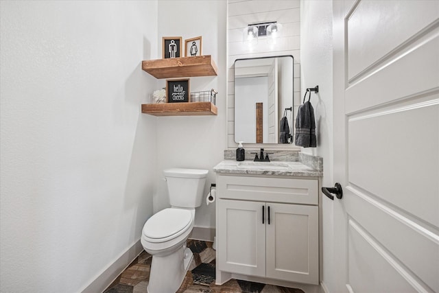 2028 Carrie Ct, Weatherford, TX 76088 - bathroom with toilet, vanity, and baseboards