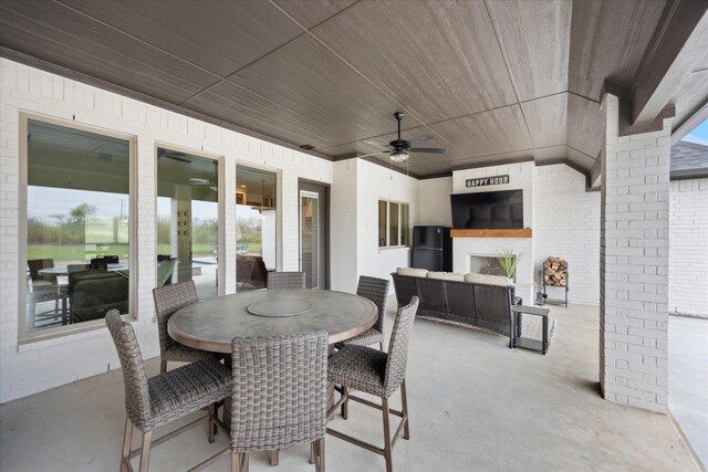 2028 Carrie Ct, Weatherford, TX 76088 - view of patio / terrace with ceiling fan, an outdoor living space with a fireplace, and outdoor dining space