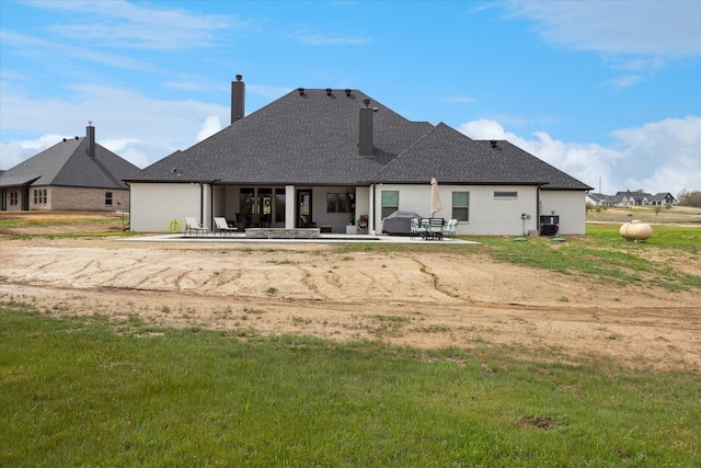 2028 Carrie Ct, Weatherford, TX 76088 - back of property with a patio area, a chimney, and a shingled roof