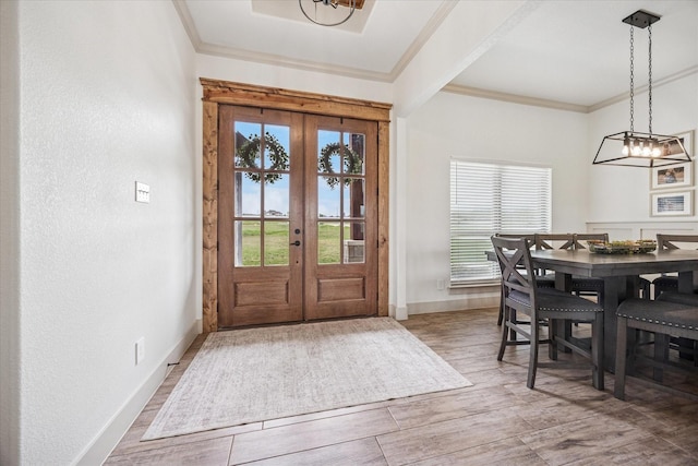 2028 Carrie Ct, Weatherford, TX 76088 - entrance foyer with french doors, baseboards, crown molding, wood finished floors, and a chandelier