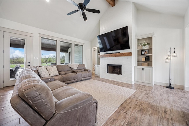 2028 Carrie Ct, Weatherford, TX 76088 - living area featuring hardwood / wood-style floors, high vaulted ceiling, beamed ceiling, a fireplace, and ceiling fan
